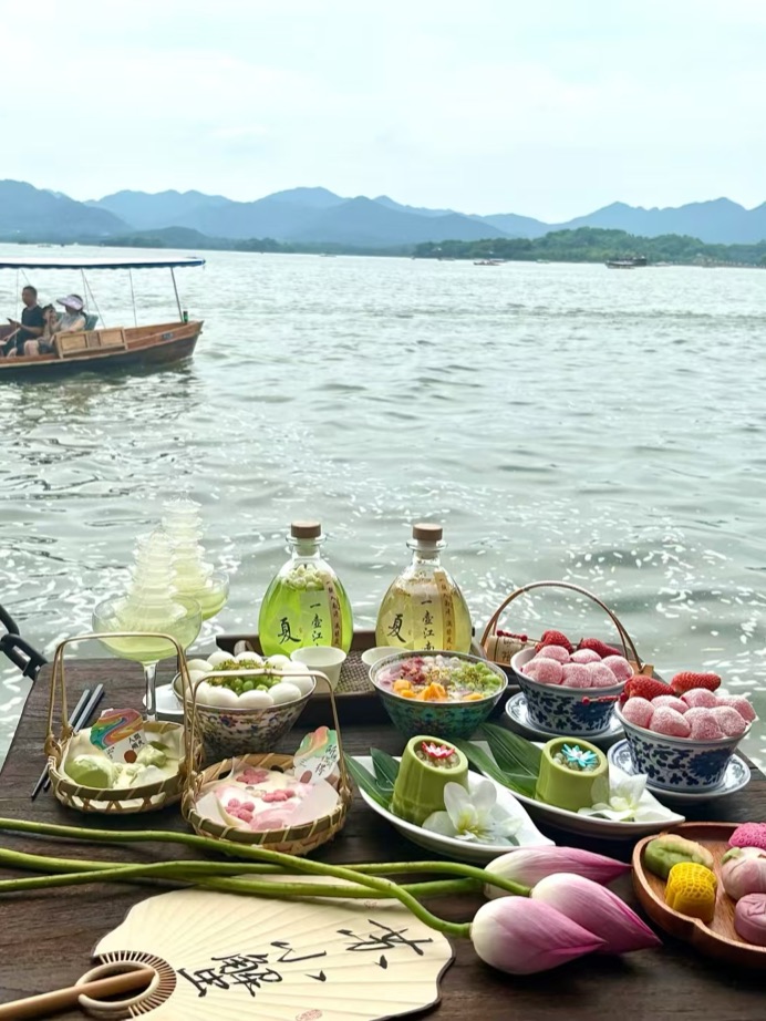 An elegant spread of Hangzhou dishes and desserts beside West Lake